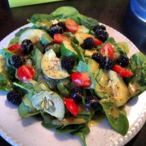 Lunch is served! Delicious spinach and cucumber salad with cherry tomatoes and blackberries, drizzled with a citrus poppyseed vinaigrette.